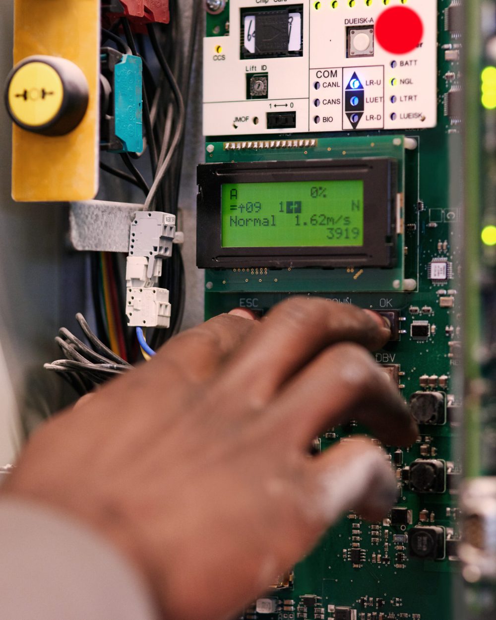 Push to start. Cropped shot of an unidentifiable man pressing a button on an electrical panel